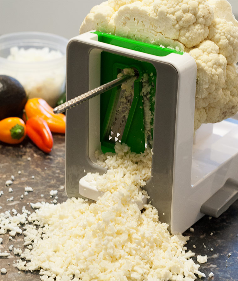 head of cauliflower on the spiralizer, making spiralized Mexican cauliflower rice