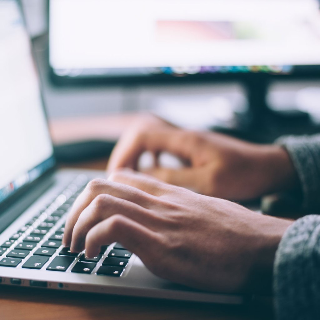 person at keyboard selecting best wordpress blog plugins